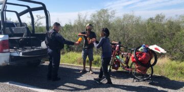 Guardia Estatal apoya con hidratación, comida y seguridad a cicloviajeros japoneses en SLM